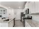 Bright kitchen with stainless steel appliances, granite countertops, and modern subway tile backsplash at 224 Shoals Bridge Rd, Acworth, GA 30102