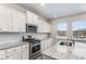 Well-lit kitchen featuring granite counters, stainless steel appliances, and modern white subway tile backsplash at 224 Shoals Bridge Rd, Acworth, GA 30102