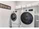 Modern laundry room with front-loading washer and dryer and ample storage space at 224 Shoals Bridge Rd, Acworth, GA 30102