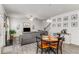 Open-concept living room featuring a fireplace, staircase, and breakfast table at 224 Shoals Bridge Rd, Acworth, GA 30102