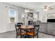 Cozy dining table in an open living area with a fireplace, gray sofa, and natural light at 224 Shoals Bridge Rd, Acworth, GA 30102