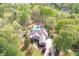 Aerial view of a home with sprawling grounds surrounded by mature trees at 8155 Legends View Ct, Cumming, GA 30028