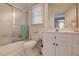 Functional bathroom featuring a tub with sliding glass doors, and a classic vanity at 8155 Legends View Ct, Cumming, GA 30028