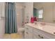 Bright bathroom with a shower and tub combination, vanity, and neutral finishes at 8155 Legends View Ct, Cumming, GA 30028