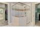Bathroom featuring glass enclosed standing shower with tile and access to the main bedroom at 8155 Legends View Ct, Cumming, GA 30028