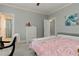Comfortable bedroom features gray walls, carpet, and access to the ensuite bathroom at 8155 Legends View Ct, Cumming, GA 30028