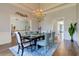 Formal dining room with a chandelier, wainscoting, and a table set for an elegant meal at 8155 Legends View Ct, Cumming, GA 30028
