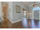 Grand foyer with hardwood floors, arched doorway, and elegant lighting creates a welcoming entrance at 8155 Legends View Ct, Cumming, GA 30028