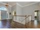 Grand foyer featuring hardwood floors, elegant staircase and a large decorative front door at 8155 Legends View Ct, Cumming, GA 30028