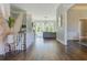 Elegant hallway with hardwood floors leading to a bright living area with large windows and natural light at 8155 Legends View Ct, Cumming, GA 30028