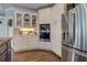 Kitchen with stainless steel refrigerator, double ovens, and built-in cabinetry at 8155 Legends View Ct, Cumming, GA 30028