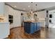 Bright open kitchen featuring stainless steel appliances, blue island and modern lighting at 8155 Legends View Ct, Cumming, GA 30028