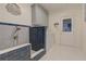 This well-lit laundry room has a dog wash station, tile flooring, and storage at 8155 Legends View Ct, Cumming, GA 30028