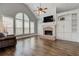 Spacious living room features a brick fireplace, hardwood floors, and large windows at 8155 Legends View Ct, Cumming, GA 30028