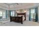 This spacious main bedroom features tray ceilings, hardwood floors, and lots of natural light at 8155 Legends View Ct, Cumming, GA 30028
