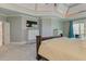 Spacious main bedroom features a tray ceiling, carpet, and access to a private screened porch at 8155 Legends View Ct, Cumming, GA 30028