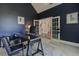 Home office with a large desk, French doors, and ample natural light, perfect for productivity at 8155 Legends View Ct, Cumming, GA 30028