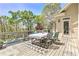 Charming outdoor patio with dining set, offering a relaxing space with natural surroundings at 8155 Legends View Ct, Cumming, GA 30028