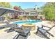 Inviting backyard with a sparkling pool, firepit and comfortable lounge chairs at 8155 Legends View Ct, Cumming, GA 30028