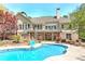 Beautiful backyard view of pool and home's exterior with a multi-level deck at 8155 Legends View Ct, Cumming, GA 30028