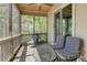 Screened porch with dark wooden railings, a ceiling fan, and dark metal furniture at 8155 Legends View Ct, Cumming, GA 30028
