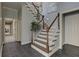 Beautiful staircase with wood and white spindles, tile entryway and gray wall color at 8155 Legends View Ct, Cumming, GA 30028