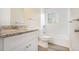 Updated bathroom with granite countertop, white cabinets, new flooring, and shower/tub combo at 869 Capitol View Nw Ave, Atlanta, GA 30318