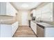 Modern kitchen features white cabinets, stainless steel appliances, and granite countertops at 869 Capitol View Nw Ave, Atlanta, GA 30318