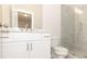 Well-lit bathroom featuring a white vanity, a mirror, and a glass-enclosed shower with marble-like tiling at 161 Basil St, Cumming, GA 30040