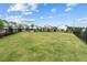 Expansive green common area in a well maintained community and with townhomes in the background at 161 Basil St, Cumming, GA 30040