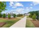 A well-maintained pool with lounge chairs, umbrellas, and landscaping in a lovely community setting at 161 Basil St, Cumming, GA 30040