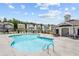 Large community pool surrounded by comfortable lounge chairs and patio tables in a tranquil setting at 161 Basil St, Cumming, GA 30040