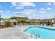 Relaxing community pool area with a pergola, lounge chairs, and manicured landscaping at 161 Basil St, Cumming, GA 30040