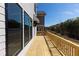 Long wooden deck with wooden railing, great for outdoor living and overlooking a wooded area at 161 Basil St, Cumming, GA 30040