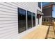 Exterior wooden deck featuring a wooden railing, offering views of the property and surroundings at 161 Basil St, Cumming, GA 30040