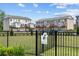View of the community dog park and townhome exteriors with rear garages and decks at 161 Basil St, Cumming, GA 30040
