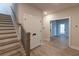 Welcoming entryway featuring hardwood floors, staircase access, and closet space at 161 Basil St, Cumming, GA 30040
