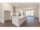 Bright open kitchen featuring an island, stainless steel appliances, and hardwood floors at 161 Basil St, Cumming, GA 30040