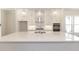 Bright kitchen featuring a large quartz island, modern stainless steel appliances, and globe pendant lights at 161 Basil St, Cumming, GA 30040