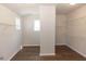 Spacious walk-in closet with hardwood floors, wire shelving, and natural light from two windows at 161 Basil St, Cumming, GA 30040