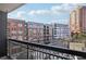 Exterior view from the balcony looking out to surrounding buildings, trees, and street at 3481 Lakeside Ne Dr # 807, Atlanta, GA 30326
