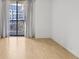 Bright bedroom featuring hardwood floors and a large window with curtain at 3481 Lakeside Ne Dr # 807, Atlanta, GA 30326