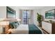 Bright bedroom featuring a bed with teal accents, a large window, modern art and a houseplant at 3481 Lakeside Ne Dr # 807, Atlanta, GA 30326