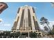Exterior shot showcasing high-rise apartment building against a blue sky with wispy clouds at 3481 Lakeside Ne Dr # 807, Atlanta, GA 30326