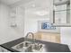 Kitchen with a view into the living room, featuring modern finishes and black counters at 3481 Lakeside Ne Dr # 807, Atlanta, GA 30326
