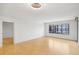 Bright living room with beautiful wood floors, white walls, and natural light from a large window at 3481 Lakeside Ne Dr # 807, Atlanta, GA 30326