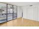 Bright living room featuring hardwood floors, a balcony, and double-door closet for storage at 3481 Lakeside Ne Dr # 807, Atlanta, GA 30326