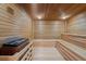 Relaxing sauna room with wooden benches, paneled walls, and traditional heater at 3481 Lakeside Ne Dr # 807, Atlanta, GA 30326
