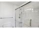 Shower room showcases a glass-enclosed shower, with white tile surround, modern fixtures, and grab bar at 3481 Lakeside Ne Dr # 807, Atlanta, GA 30326