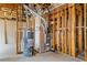 Basement mechanical area featuring a hot water tank, furnace, and exposed framing, showcasing the home's essential systems at 4695 Ferncrest Pl, Douglasville, GA 30135